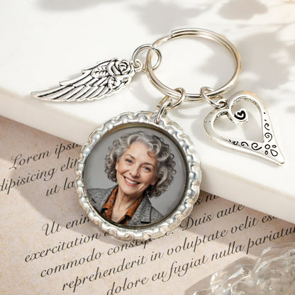 Close-up of personalised photo insert in heart wing keychain showing clear printed image and crisp engraving