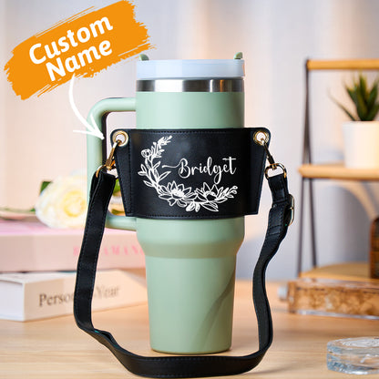 Adjustable strap detail and metal hardware on personalised floral PU leather 40oz Stanley tumbler carrier bag for crossbody wear