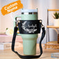 Adjustable strap detail and metal hardware on personalised floral PU leather 40oz Stanley tumbler carrier bag for crossbody wear
