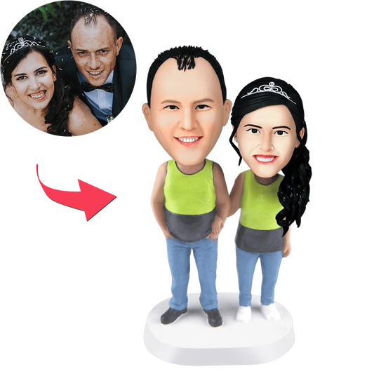 Custom couple bobblehead in matching tank tops with engraved text on base — personalised anniversary gift handcrafted from food-grade polymer clay.