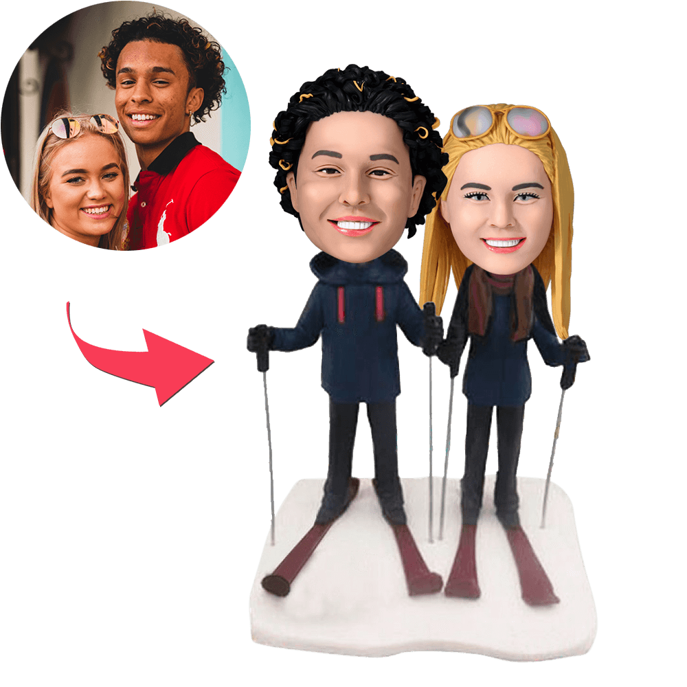 Personalised skiing couple bobblehead – hand‑sculpted polymer clay figurine of a skiing pair with customised faces and hairstyles and engraved base, ideal anniversary or wedding gift