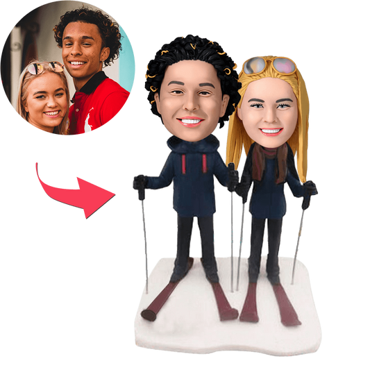 Personalised skiing couple bobblehead – hand‑sculpted polymer clay figurine of a skiing pair with customised faces and hairstyles and engraved base, ideal anniversary or wedding gift