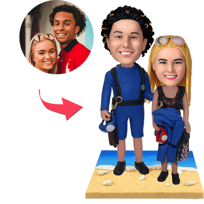 Wetsuit beach couple custom bobblehead — hand-crafted personalised polymer clay figurines in wetsuits with engraved base
