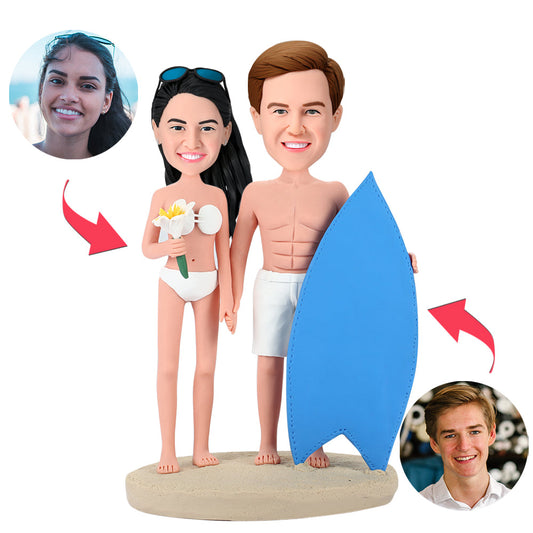 Personalised surfing couple bobblehead handcrafted in polymer clay, couple riding a surfboard with engraved name on the base — ideal wedding or anniversary keepsake