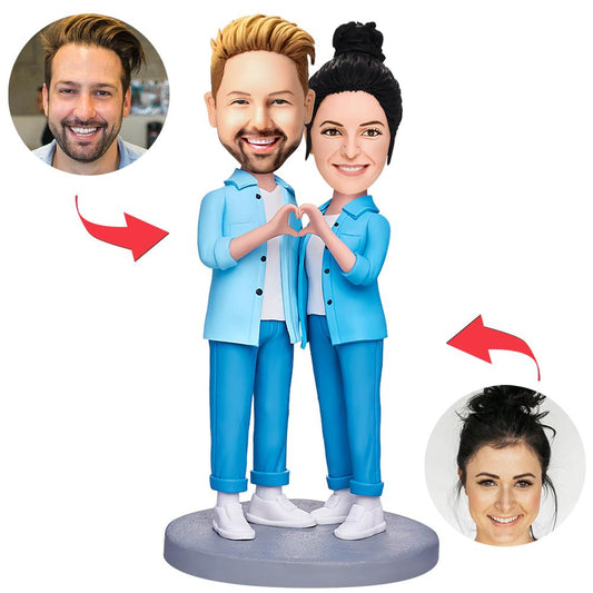 Front view of personalised couple hands-in-heart bobbleheads, handcrafted polymer clay keepsake with engraved base and customised heads – ideal wedding or anniversary gift