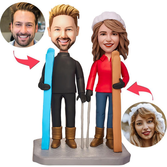 Personalised couple skiing bobbleheads – handcrafted polymer clay figures on skis with engraved base text and custom heads