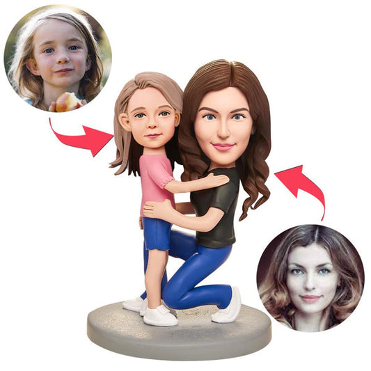Personalised Mother & Child Bobblehead — custom polymer clay figurine of a mother holding a child with engraved text on the base, front view, ideal keepsake gift