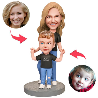 Personalised mother and son bobblehead in black shirts — polymer‑clay custom heads with engraved text plate, bespoke keepsake gift