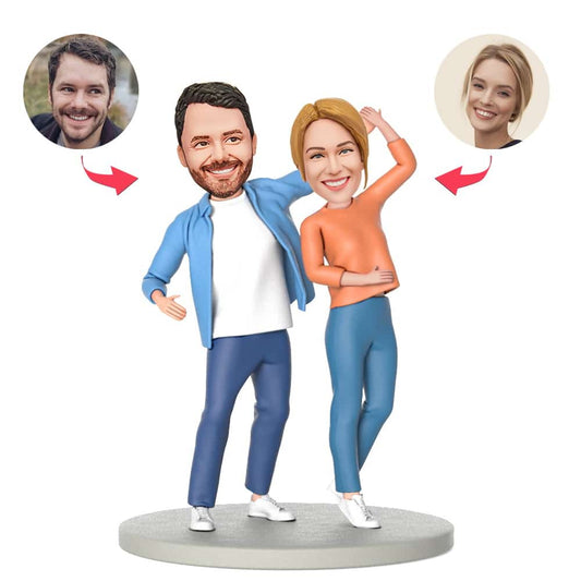 Personalised couple holding hands dancing bobblehead in polymer clay with customised heads and engraved text on the base, ideal personalised couple bobblehead gift