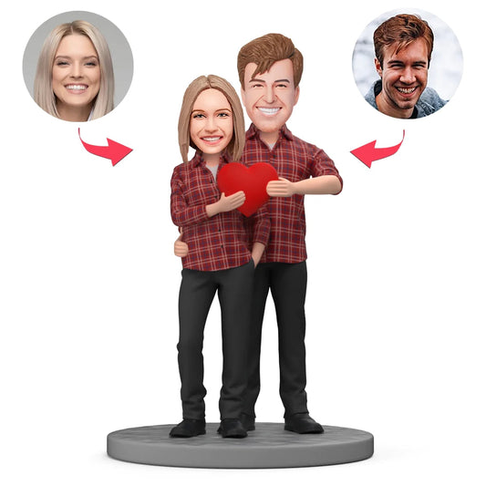 Personalised polymer clay couple bobblehead in red plaid shirts with engraved text on the base, featuring custom head likeness and hairstyle — perfect engraved anniversary or wedding keepsake