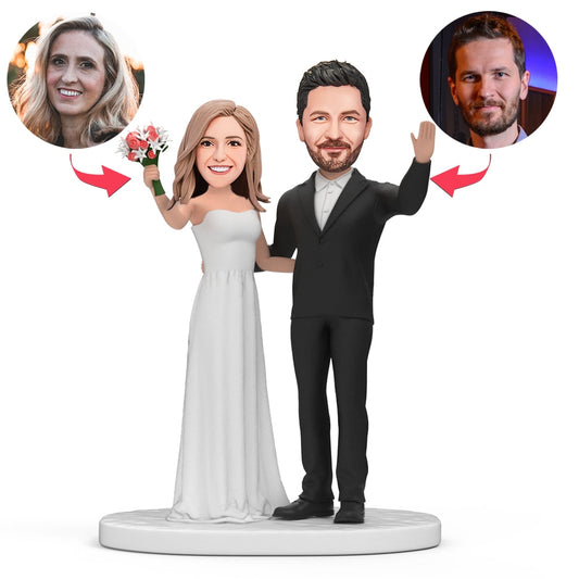 Personalised groom and bride bobblehead waving with flowers — hand-crafted polymer clay wedding keepsake with customised head likeness and engraved name plaque