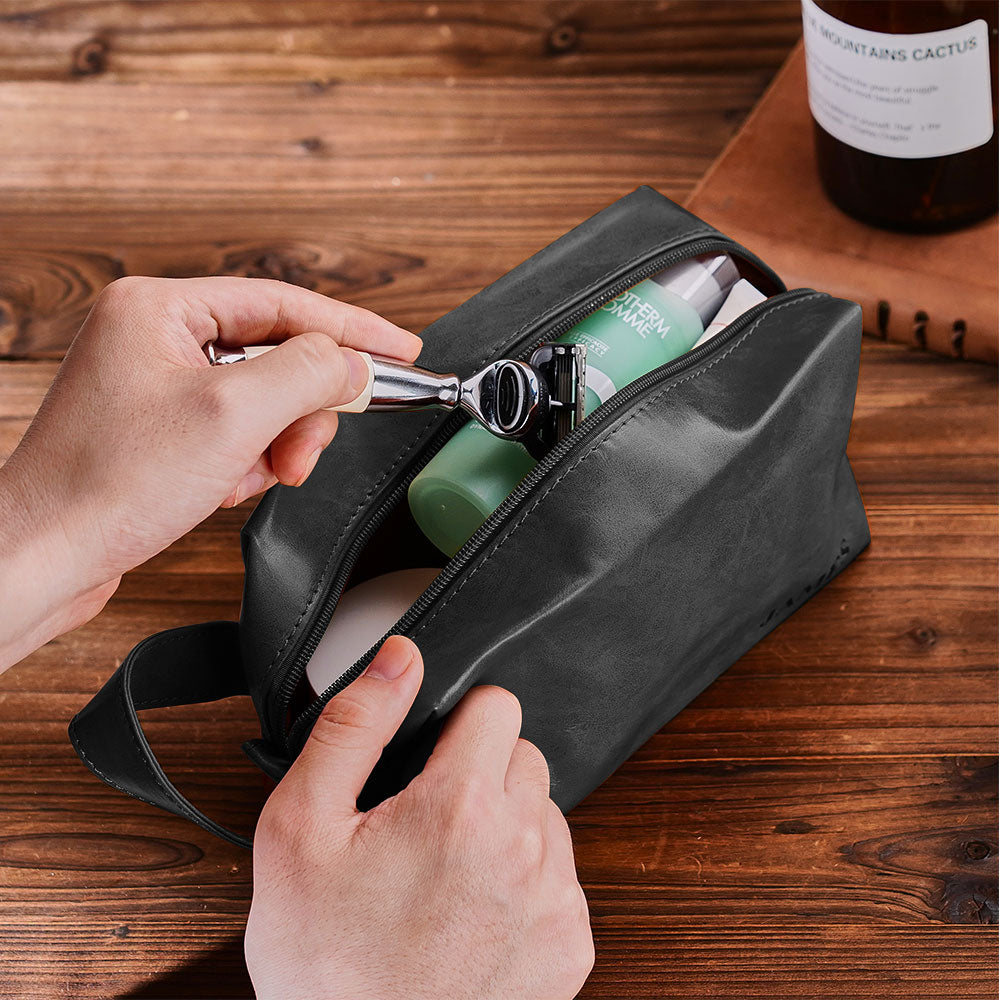 Open personalised toiletry bag showing roomy interior and organisation — engraved travel pouch for grooming essentials and cosmetics.