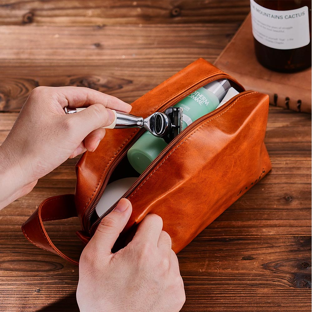 Close-up of custom engraved name on high-quality PU leather — premium personalised men's wash bag detail for groomsmen or Father's Day gifts.