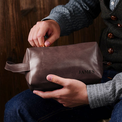 Lifestyle shot of engraved PU leather toiletry bag with luggage — stylish personalised dopp kit for travel, weekends and gym trips.