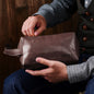 Lifestyle shot of engraved PU leather toiletry bag with luggage — stylish personalised dopp kit for travel, weekends and gym trips.