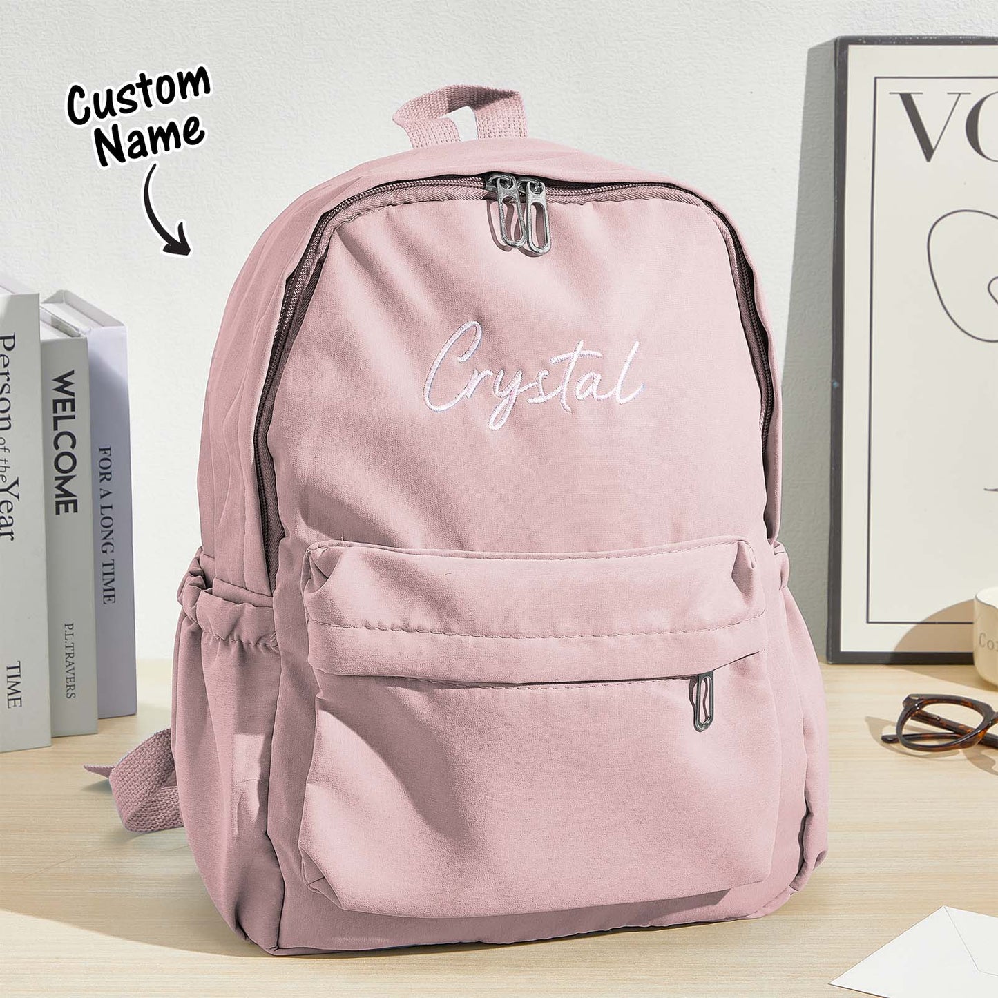 Angled view of canvas personalised backpack showing roomy main compartment and two side pockets, embroidered name child school bag