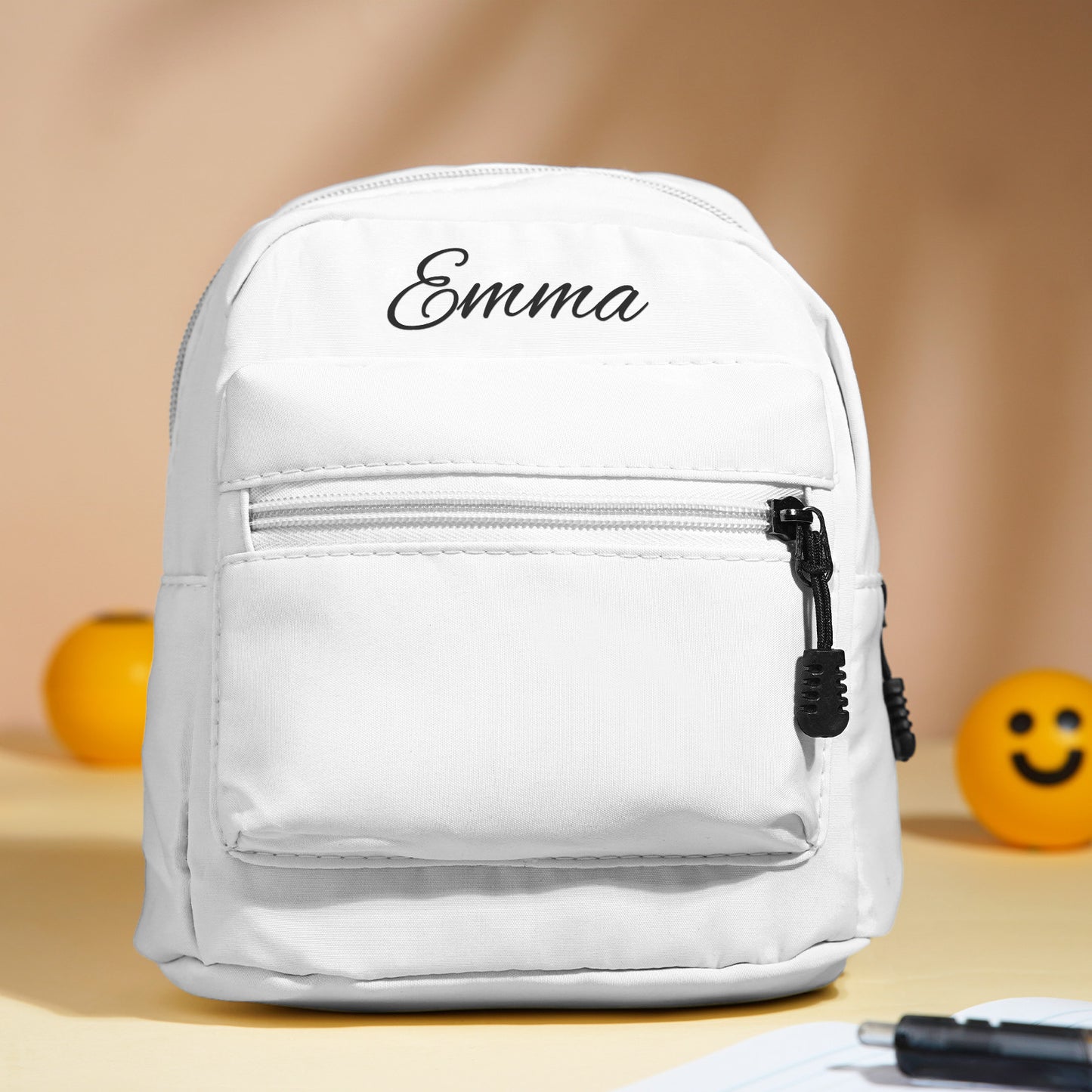Personalised mini backpack open to reveal roomy main compartment for snacks, small toys and daily essentials with embroidered name detail