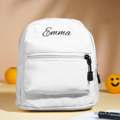 Personalised mini backpack open to reveal roomy main compartment for snacks, small toys and daily essentials with embroidered name detail