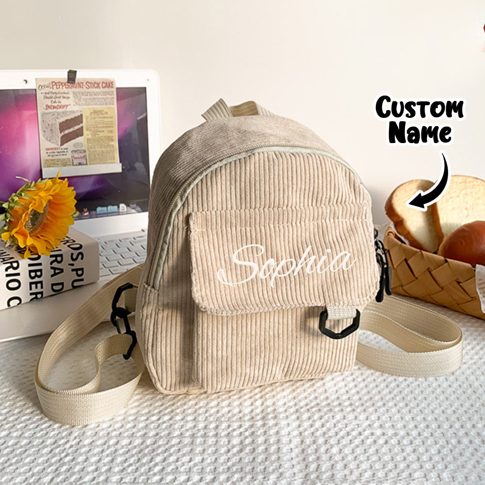 Mini school bag open to show roomy main compartment for snacks and small books — personalised embroidered name backpack