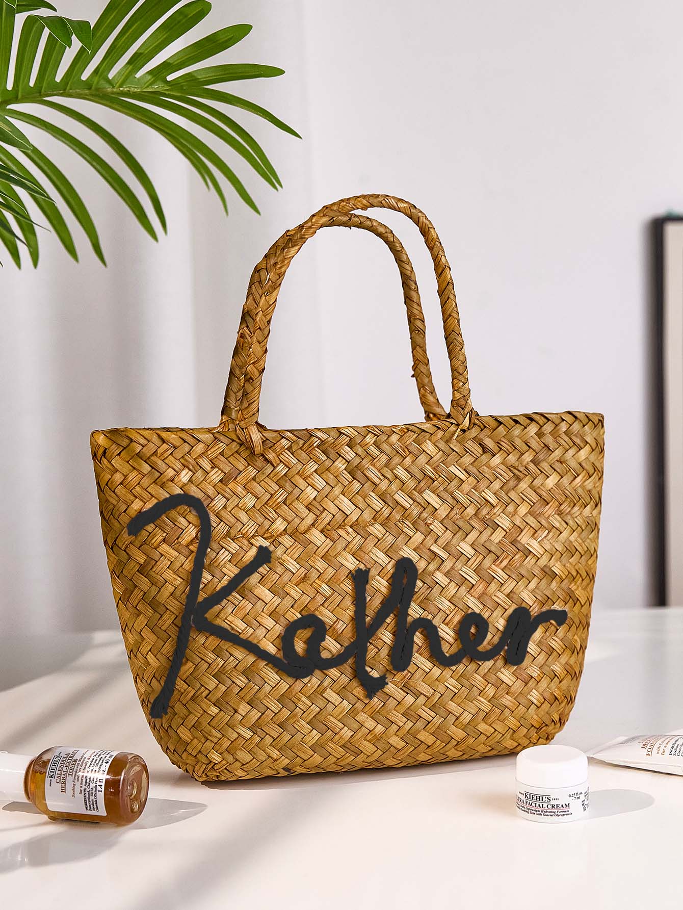 Back view of personalised bohemian straw bucket bag in natural tones, a stylish beach wedding accessory and travel companion