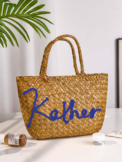 Lifestyle image of personalised boho straw bucket bag at the seaside, ideal for holidays, parties and as a thoughtful gift