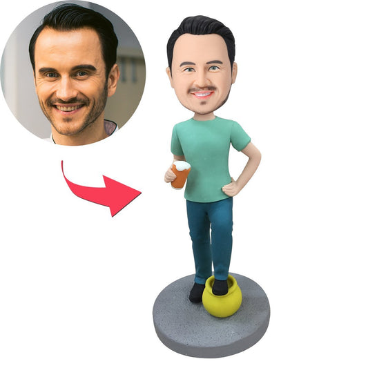 Personalised polymer-clay bobblehead of a man holding a beer and a pot of gold, engraved base text and customised head likeness, ideal Father’s Day or groomsmen gift