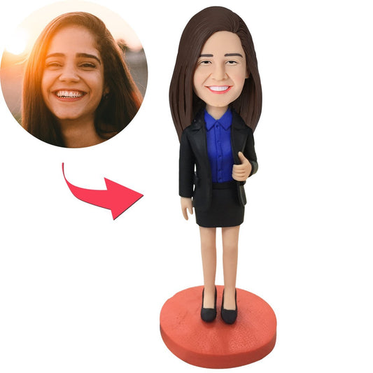 Angled view of personalised female executive bobblehead showing face sculpt detail and engraved trophy base, ideal promotion or congratulations gift