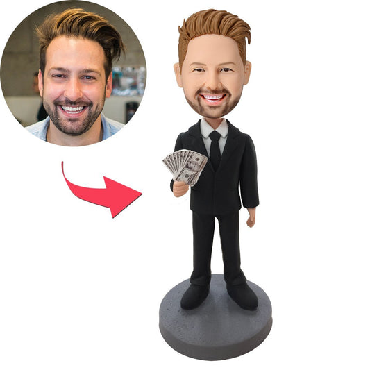 Personalised male executive bobblehead in a black suit holding money, polymer clay desk ornament with engraved base – custom executive gift