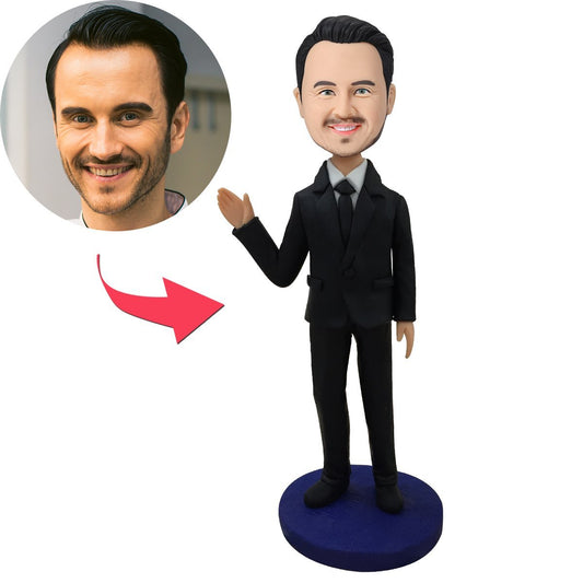 Handcrafted polymer clay personalised bobblehead of a male executive in a black suit waving, custom head from your photo with engraved nameplate – ideal personalised corporate gift