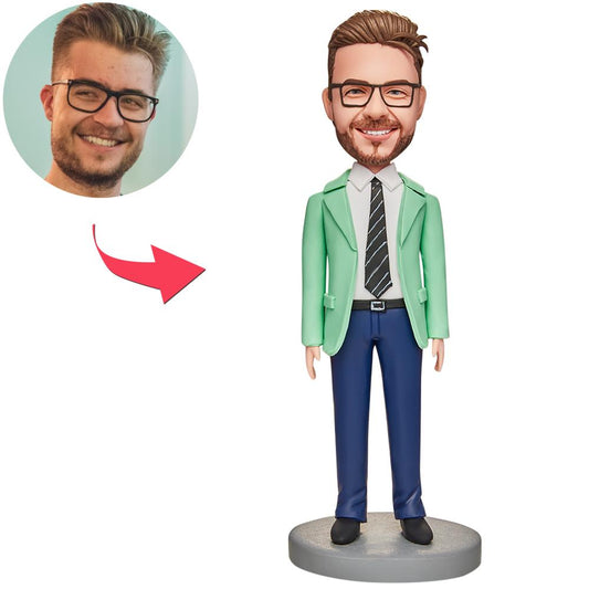 Handmade polymer clay businessman bobblehead in green suit with personalised custom head likeness and engraved base text — ideal personalised desk gift for him