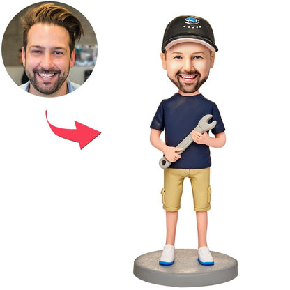 Personalised man bobblehead holding a spanner (wrench), handmade polymer clay with custom sculpted face and engraved base — perfect mechanic or tradie gift