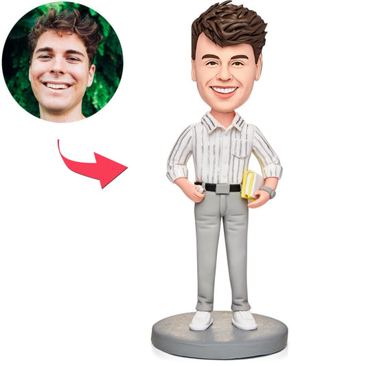 Personalised male teacher bobblehead holding a book – handmade polymer clay figurine with customised face and engraved base for name or message