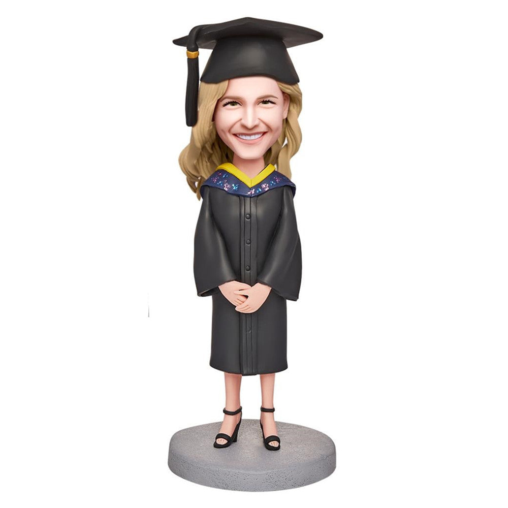 Happy Graduation Girl personalised bobblehead in polymer clay with engraved base text, customised head to match photos and fixed graduation outfit