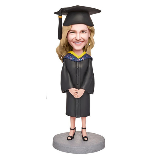 Happy Graduation Girl personalised bobblehead in polymer clay with engraved base text, customised head to match photos and fixed graduation outfit