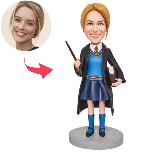 Personalised graduation girl bobblehead holding a book with engraved base, hand-crafted polymer clay and a customised head — the perfect engraved graduation keepsake gift for graduates in the UK and Australia