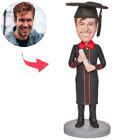 Personalised graduation bobblehead of a happy boy holding a certificate with engraved text on the base, polymer clay engraved graduation figurine — ideal personalised grad gift for Australia and the UK