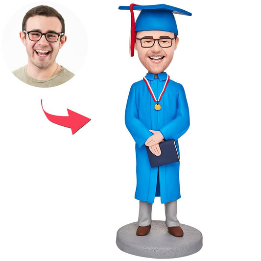 Personalised graduation bobblehead of a boy in a blue gown – polymer clay figure with customised head from your photo and engraved name on the base, ideal graduation gift for UK & Australia
