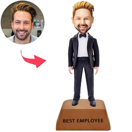 Side view of personalised businessman bobblehead showing customised facial likeness, suit detail and engraved nameplate on trophy-style base