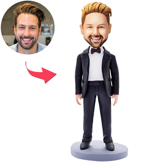 Side view of personalised businessman bobblehead showing customised facial likeness, suit detail and engraved nameplate on trophy-style base