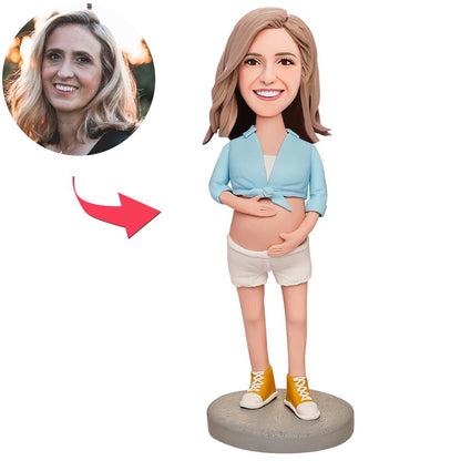 Handmade personalised pregnant woman bobblehead in blue outfit – custom polymer clay maternity keepsake with engraved name, ideal baby shower gift for expectant mum