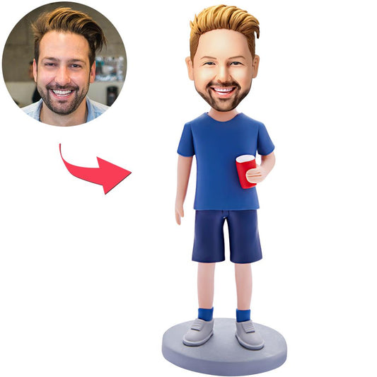 Personalised bobblehead of a man holding a water glass — handcrafted polymer clay figure with customised head from your photo and engraved text on the base