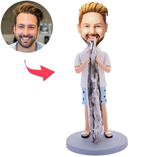 Personalised polymer clay bobblehead of a man holding a large fish, head customised from your photo with engraved base for name or date — custom fisherman figurine gift
