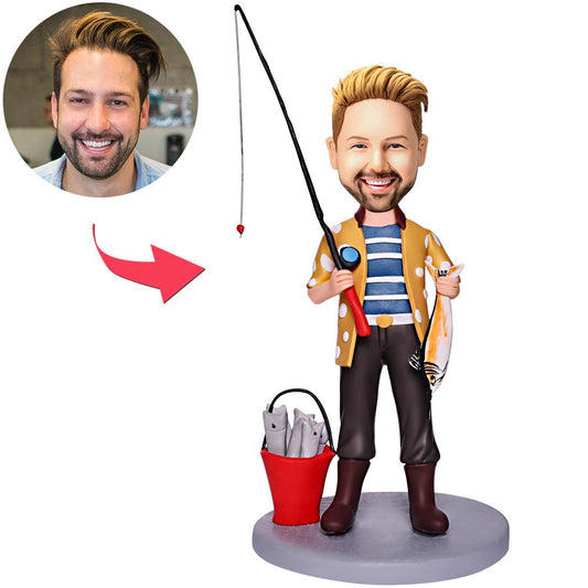 Personalised bobblehead of a man holding a bucket of fish, handmade polymer clay custom fisherman gift with engraved text on the base