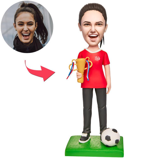 Soccer Champion personalised bobblehead in polymer clay, customised head from your photo with hairstyle and expression matched, engraved base with custom text — unique football gift or trophy alternative