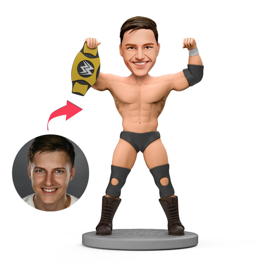 Front view of a personalised champion wrestler bobblehead with gold belt, polymer clay finish and engraved base — a custom champion bobblehead ideal as a personalised sports trophy