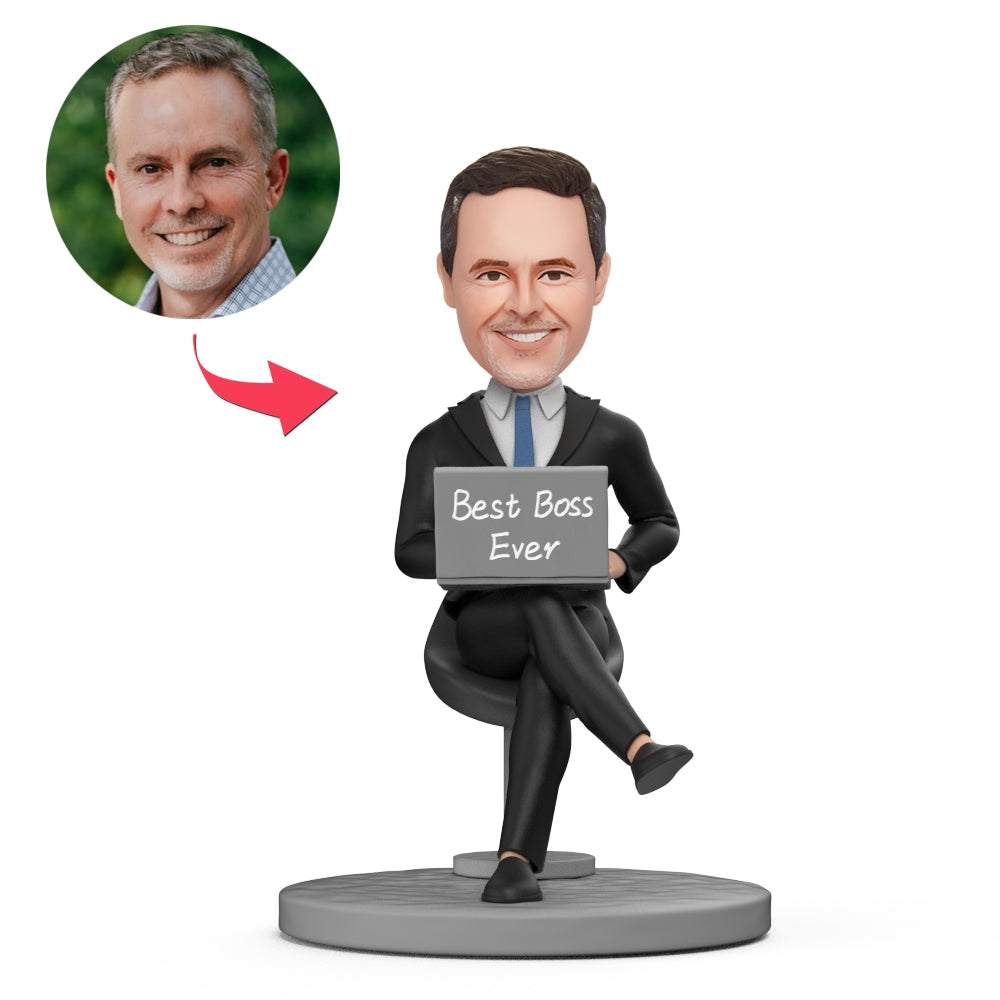 Sitting in chair with computer personalised bobblehead 'BEST BOSS EVER' — custom head from a supplied photo, polymer clay body and engraved base; ideal personalised face gift for a boss or colleague