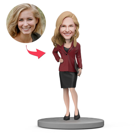 Personalised female boss bobblehead in red suit with short skirt and engraved base — custom head, polymer clay personalised boss gift