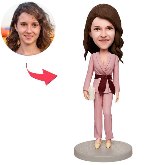 Personalised bobblehead office lady in a pink suit, hand‑sculpted polymer clay custom face figurine with engraved text on the base, perfect personalised gift for colleagues or loved ones