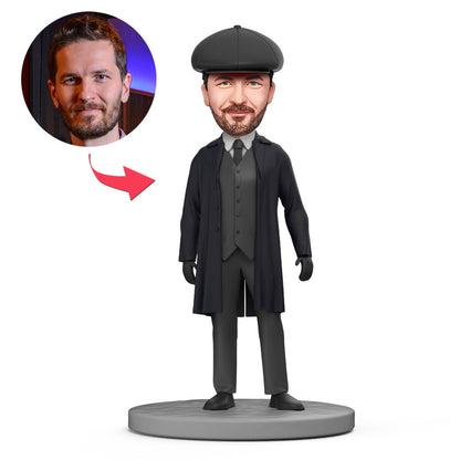 Black Trench Coat Shelby personalised bobblehead — handcrafted polymer clay custom head mini figure in a black trench coat, personalised face sculpted from your photo, choice of bobble or stationary head and engraved base for name or date, ideal personalised face gift
