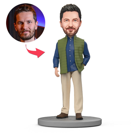 Front view of handcrafted polymer clay personalised bobblehead in blue shirt and green vest with engraved text on the base, ideal personalised gift